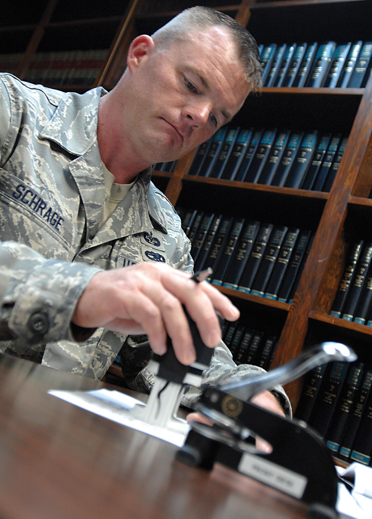 Tech. Sgt. Carter Schrage, 22nd Air Refueling Wing Legal Office, notarizes legal documents, Oct. 20, 2009, at McConnell Air Force Base, Kan. The Elgin, Neb., native is paralegal and the noncommissioned officer in charge of the general law section here. (U.S. Air Force photo/Senior Airman Jessica Lockoski) 