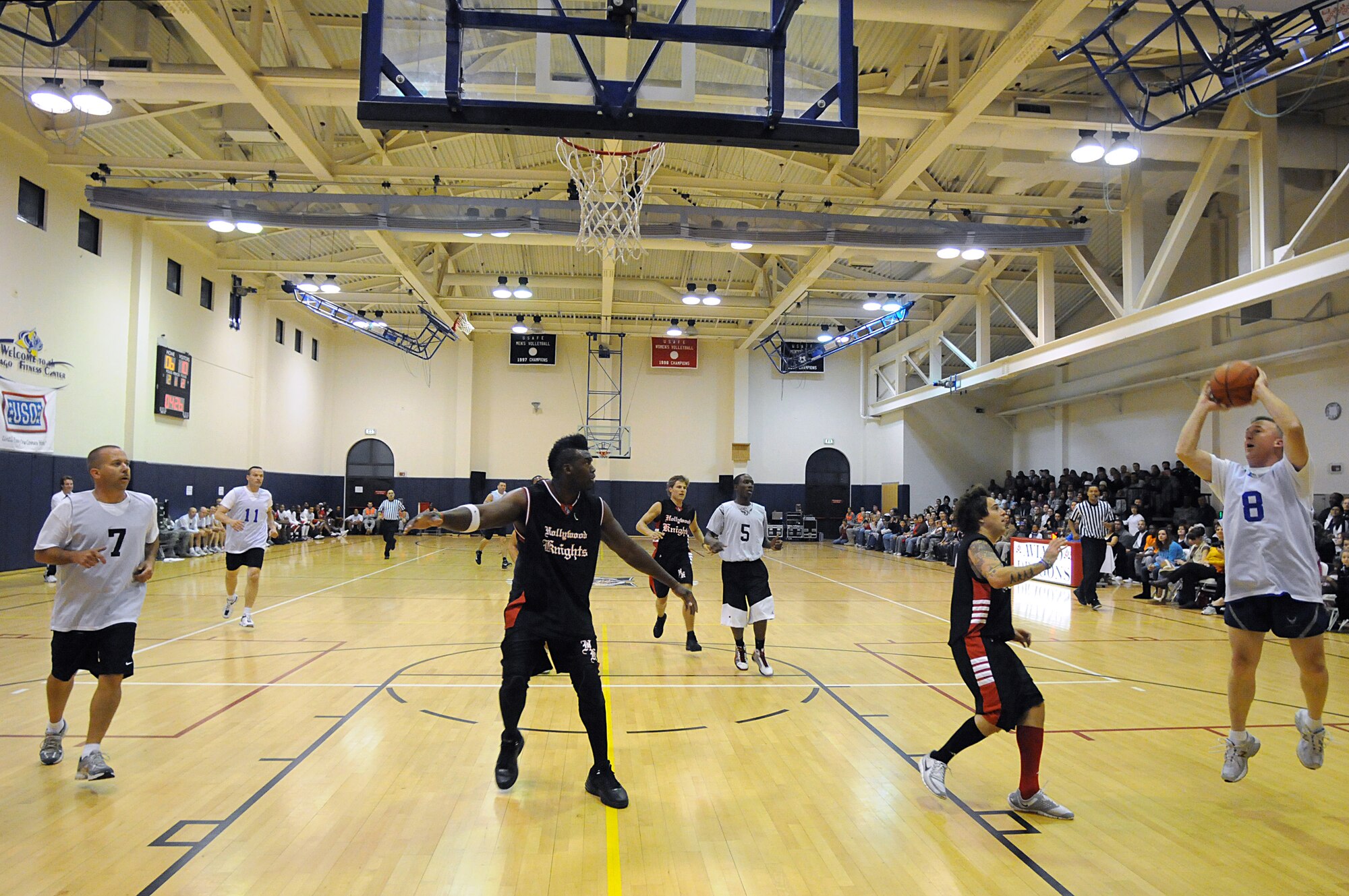 Chief Master Sgt. Mike Cote, 31st Mission Support Group chief enlisted manager, shoots a jump shot during a basketball game against the Hollywood Knights Oct. 20, 2009 at the Dragon Fitness Center on Aviano Air Base, Italy. The Hollywood Knights celebrity basketball team competed in a game against the 31st Fighter Wing leadership and members of the base's varsity basketball team as part of a USO Tour. The home team beat the Hollywood Nights 82-76. The celebrities signed autographs and took photos with fans during halftime and after the game. The Hollywood Knights consists of television, motion picture and musical recording stars. (U.S. Air Force photo/ Staff Sgt. Patrick Dixon)