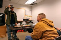 MINOT AIR FORCE BASE, N.D. -- Tech. Sgt. Jeremy Meier, 5th Operations Group noncommissioned officer-in-charge target intelligence and hunters safety course instructor, demonstrates the safe procedures for handling a .45-caliber pistol. The safety course is designed to put safe and educated hunters into the field. (U.S. Air Force photo by Senior Airman Matthew Smith)