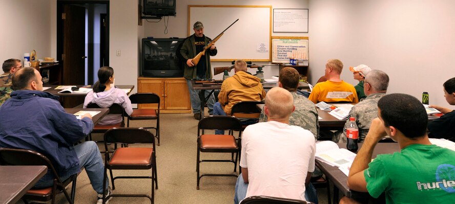 MINOT AIR FORCE BASE, N.D. -- Tech. Sgt. Jeremy Meier, 5th Operations Group noncommissioned officer-in-charge target intelligence and hunters safety course instructor, demonstrates the safe procedures for handling a 20-gauge shotgun. The safety course is designed to put safe and educated hunters into the field. (U.S. Air Force photo by Senior Airman Matthew Smith)