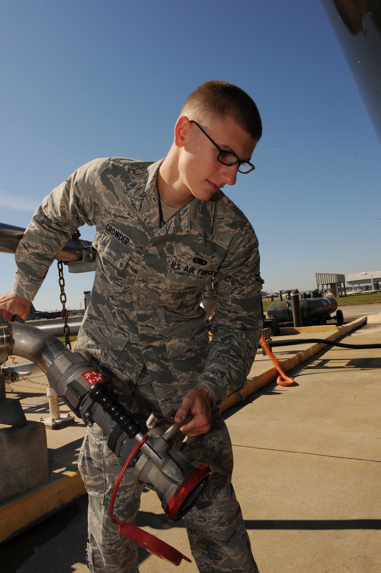 Airman First Class Kevin Crowder, a 19th Logistics Readiness Squadron fuel distribution operator, positions a pantograph arm Oct. 21 to attach to an R-11 refueling truck to begin refueling 6,000 gallons of jet fuel to service the C-130 fleet on base. The fuels flight is dedicated to developing and implementing fuels which are better for the environment, based on renewable resources, reduce dependance on foreign oil and save money. (U.S. Air Force photo by Staff Sgt. Chad Chisholm) 