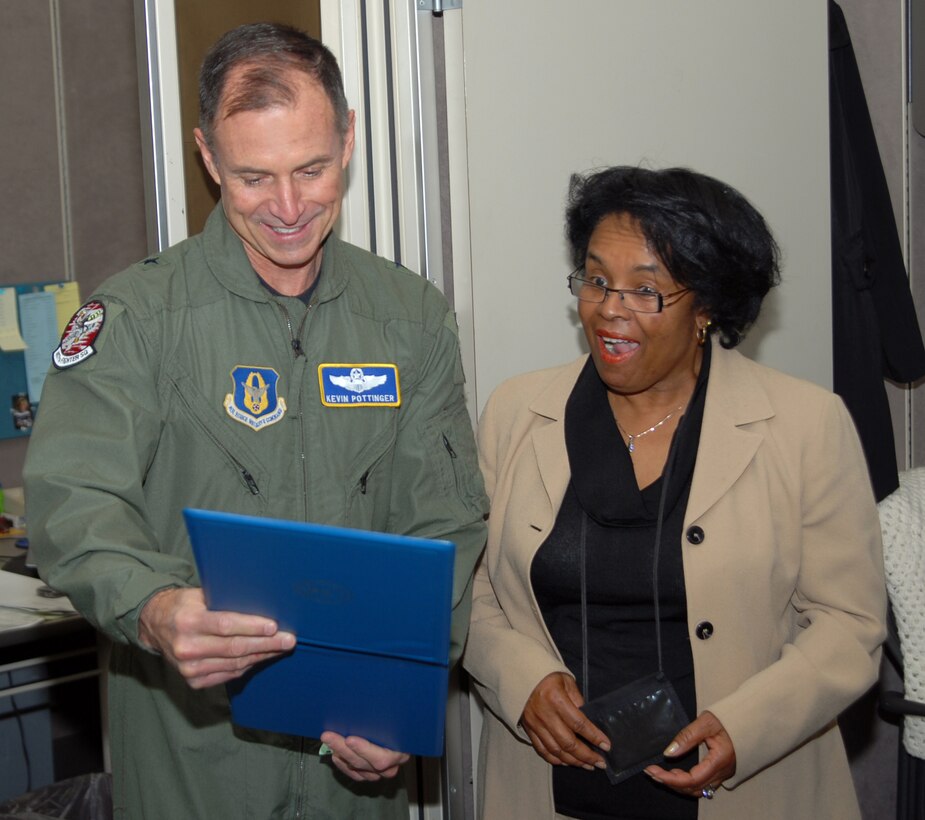 Nellie Herbert (right) gets a surprise when Brig. Gen. Kevin Pottinger, ARPC commander, presents her with a certificate of service for surpassing 30 years of federal employment. Nearly one-fourth of ARPC's civilian workforce has more than 30 years of service. (U.S. Air Force photo/Dwayne Beuthel) 