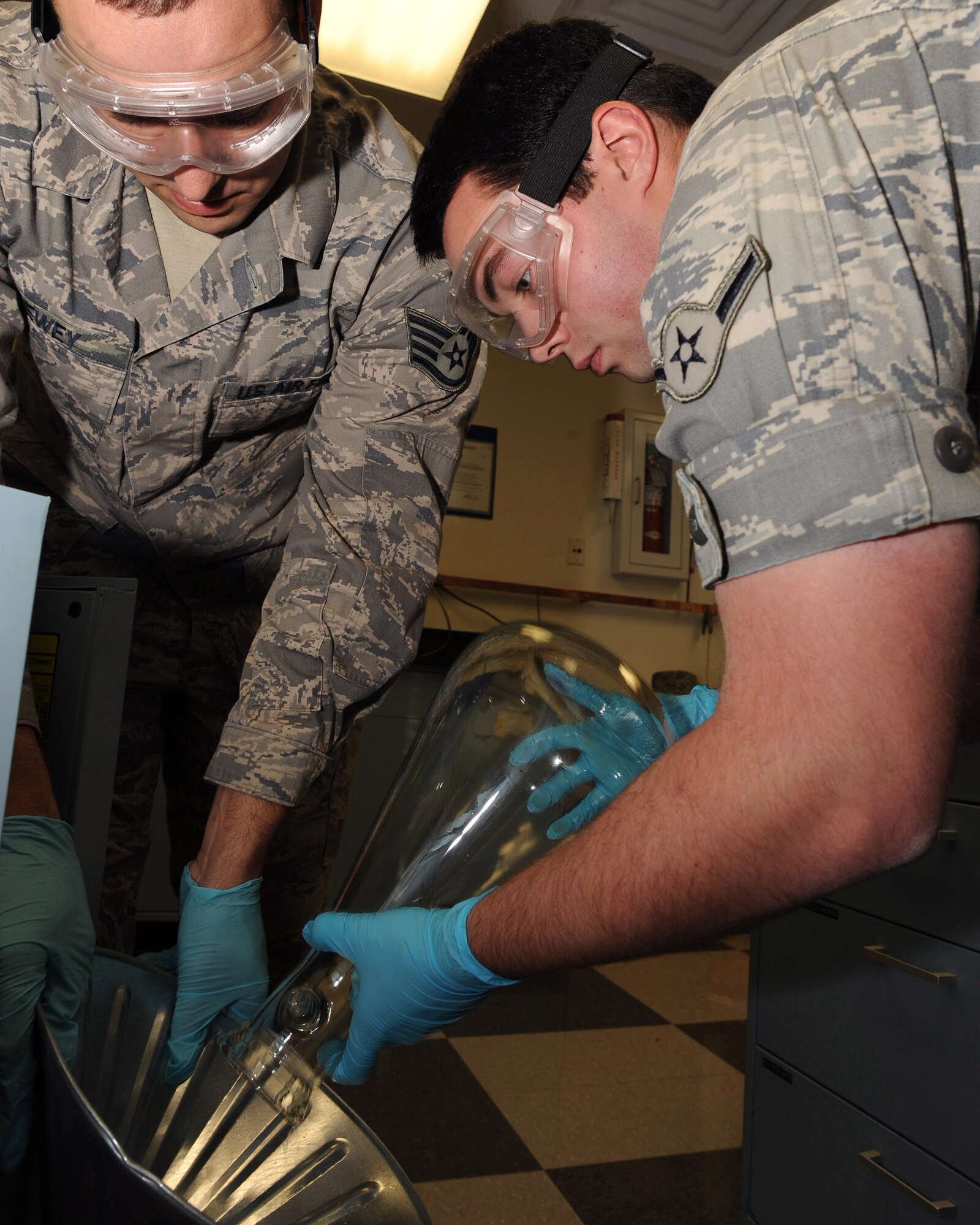 Airman Lucas Berg, a 19th Logistics Readiness Squadron fuels lab technician, pours excess Jet Propulsion 8 (JP-8) fuel into a funnel held by Staff Sgt. Clint Lewey, a 19th LRS fuels lab technician Oct. 21. The fuels lab technicians are responsible for making sure the fuel is checked for quality, cleanliness, and the mixture of the fuel is within specifications. (U.S. Air Force photo by Staff Sgt. Chad Chisholm)