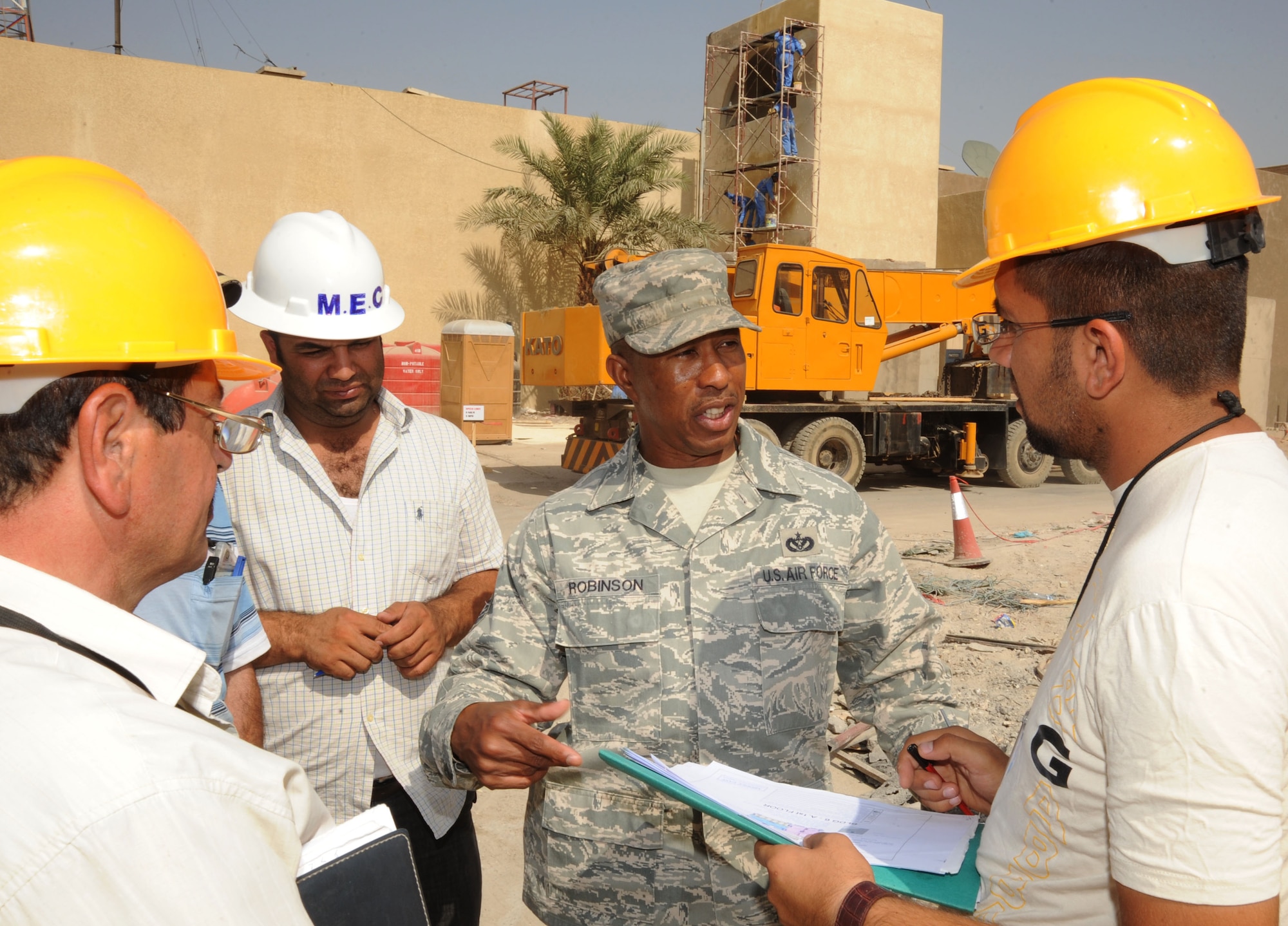 BAGHDAD -- Air Force Master Sgt. Tommy Robinson, joint area support group department of public works Team 2 noncommissioned officer in charge, coordinates with Iraqi contractors responsible for construction projects located in the International Zone Oct. 18, 2009. Sergeant Robinson is responsible for ensuring contractors follow contract agreements, safety rules and national electric codes. He is deployed from Luke Air Force Base, Ariz., and hails from Graceville, Fla.  (U.S. Air Force photo/Tech. Sgt. Johnny L. Saldivar)