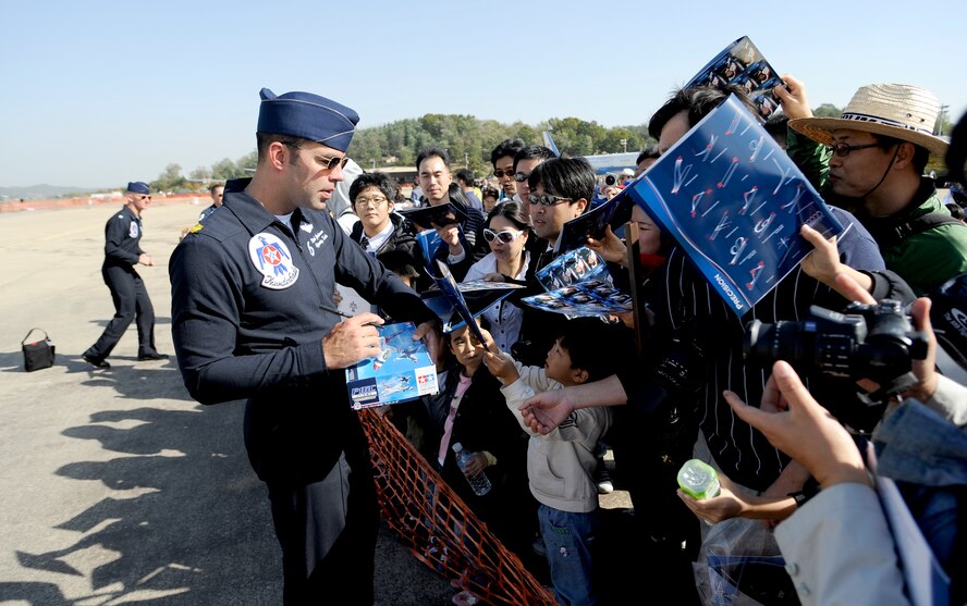 Thunderbird pilot Maj. Rick Goodman signs autographs for spectators attending Air Power Day 2009 at Osan Air Base, Republic of Korea, Oct. 21. (U.S. Air Force photo/Staff Sgt. Brian Ferguson)