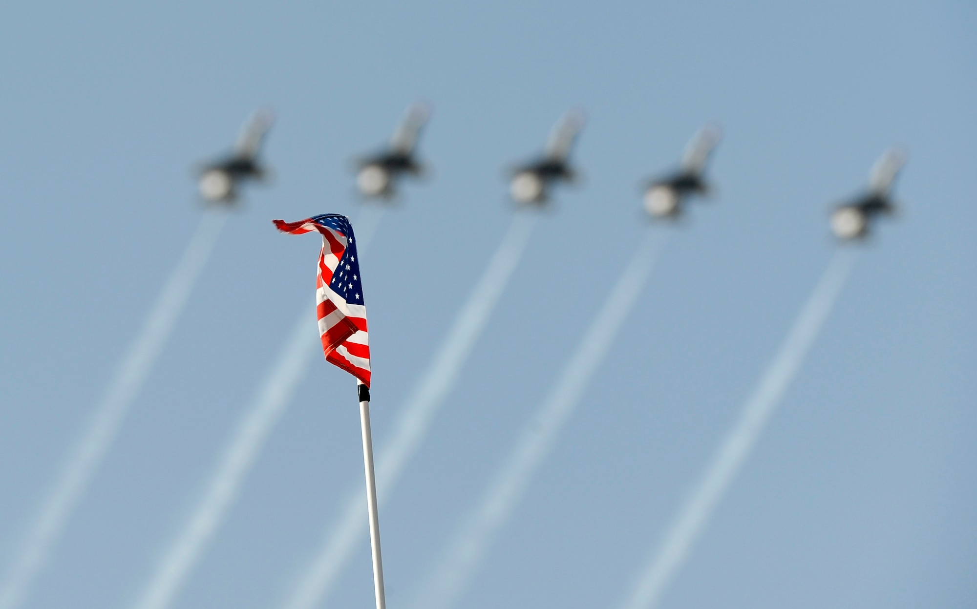 A gust of wind waves an American flag as the U.S. Air Force Air Demonstration Squadron, the Thunderbirds, perform during Air Power day at Osan Air Base, Republic of Korea, Oct. 21. (U.S. Air Force photo/Staff Sgt. Brian Ferguson)



