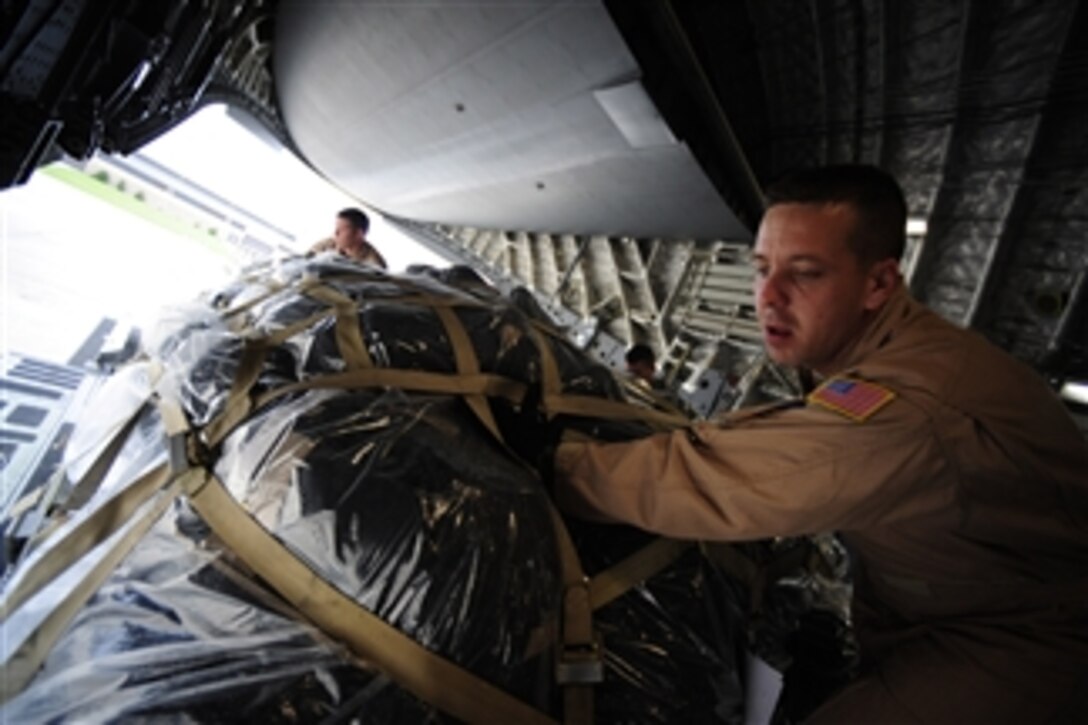 U.S. Air Force Tech. Sgt. Greg Drury (right) and Staff Sgt. Gabriel Reams load cargo onto a C-17 Globemaster III aircraft at Pope Air Force Base, N.C., during Exercise Bright Star on Oct. 11, 2009.  Drury and Reams are loadmasters assigned to the 8th Airlift Squadron.  