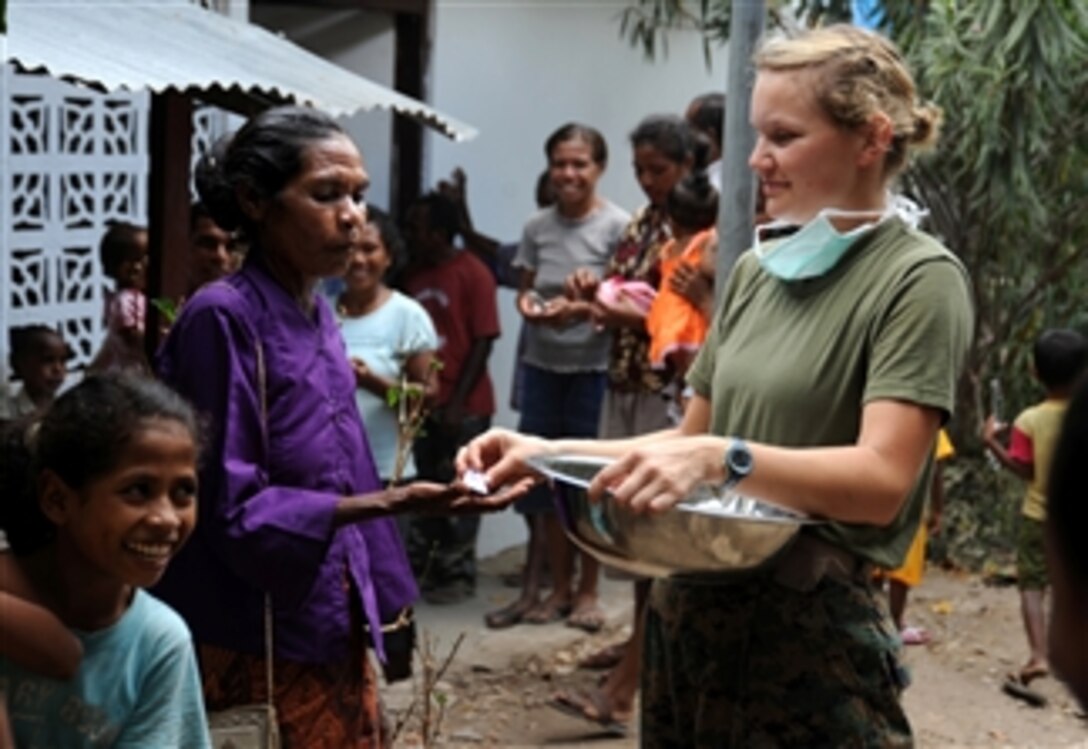 U.S. Navy Petty Officer 2nd Class Rachel Arndt, assigned to the 11th Marine Expeditionary Unit, hands out toothpaste at a clinic in Laga, Timor-Leste, on Oct. 21, 2009.  
