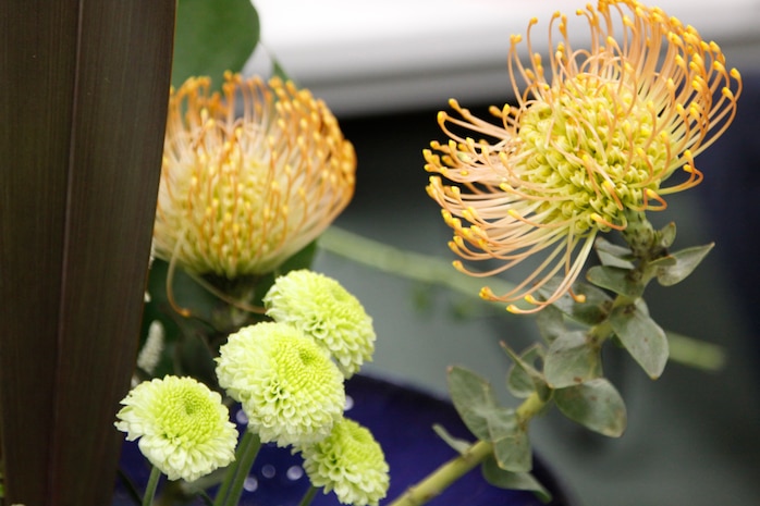 A flower arrangement being worked on by Nina Woods, an Ikebana student, is displayed on the table during an Ikebana class taught at the station library here Oct. 22. Students of the class are required to bring in their own vase and flower cutters and pay the instructor for flowers she provides for the class.