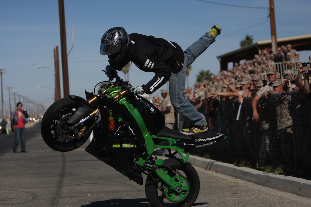 Kyle Rappaport, a stunt rider at the Marine Corps Communications-Electronics School Safety Fair, shows off a flamingo on Bourke Street Oct. 23. The stunt bike performers are from different professional riding groups, and came together to give MCCES their demonstration and words on safety.