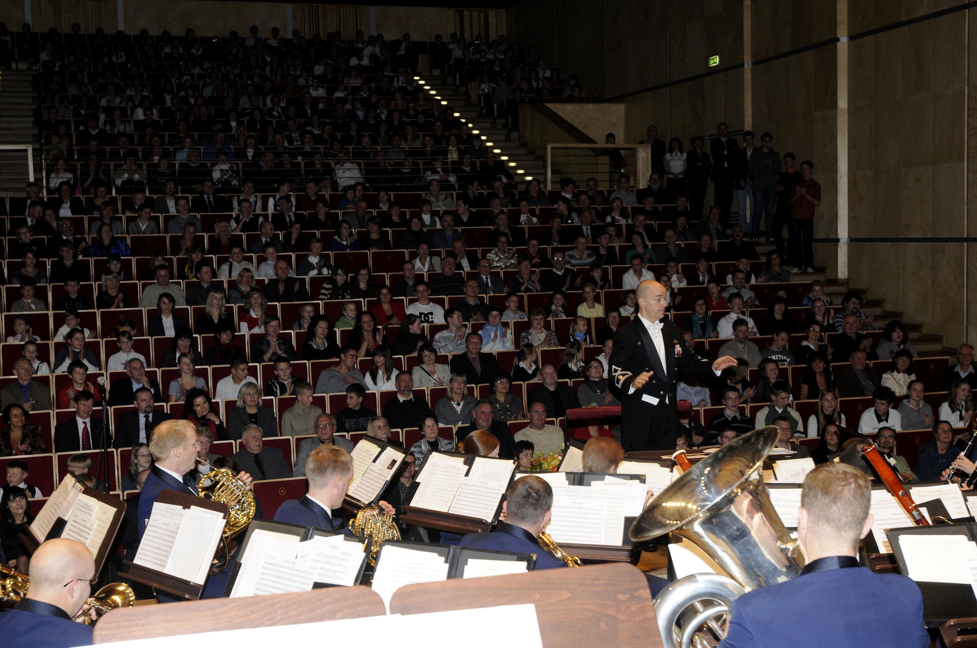 OPOLE, Poland – Maj. Matt Henry, U.S. Air Forces in Europe Band commander and musical director, conducts the concert band during a Glenn Miller medley encore here Oct. 21 at the Filharmonia Opolska im. Jozefa Elsnera.  The band is performing six shows in six days Oct. 20-25.  The concert series is in support of the USAFE Commander Gen. Roger Brady’s international relations program in partnership with the U.S. State Department to help commemorate 90 years of Polish-American cooperation.  (U.S. Air Force photo/Master Sgt. Kelley J. Stewart)