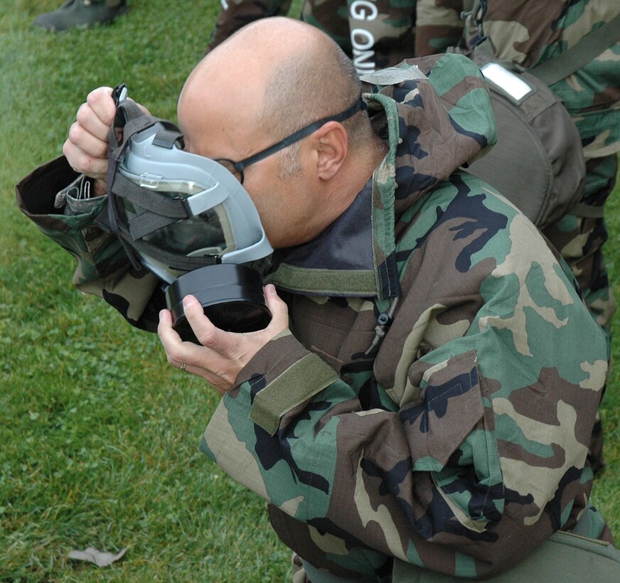 Chaplain (Maj.) Pierre Allegre, 446th Airlift Wing, dons his mask in one last practice session for the Operational Readioness Inspection. Both the 446th and 62nd Airlift Wings have been preparing for well over a year for the Operational Readiness Inspection set to begin about Oct. 24. (U.S. Air Force photo/Sandra Pishner)