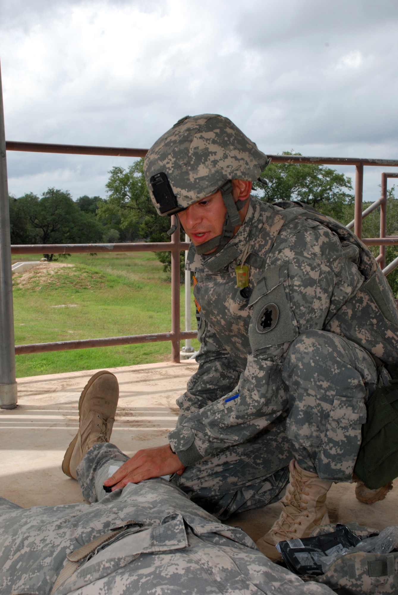 FORT SAM HOUSTON, Texas — Spc. Carlos Morales, 1st Battalion, 228th Aviation Regiment, U.S. Army South, treats a mock casualty during the U.S. Army South Soldier of the Quarter competition here. (Photo by Robert R. Ramon, U.S. Army South Public Affairs)