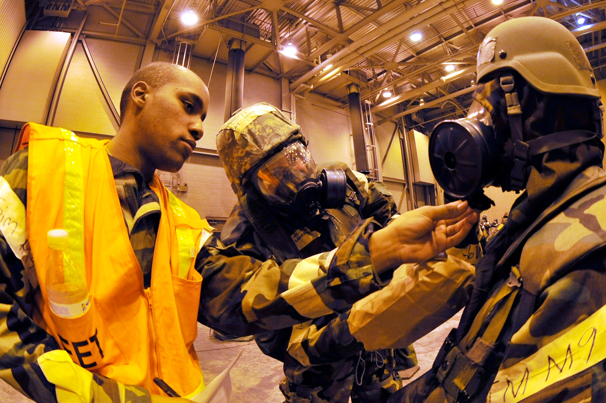 Airman 1st Class Chioke Buckley guides Airmen through proper buddy checks and decontamination during a training evaluation Oct. 23, 2009, Eielson Air Force Base, Alaska. The evaluation tests the ability of Airmen on how to survive and operate in a chemical, biological, radiological, nuclear and high yield explosive environment. Airman Buckley is assigned to the 354th Civil Engineering Squadron. (U.S. Air Force photo/Staff Sgt. Christopher Boitz)