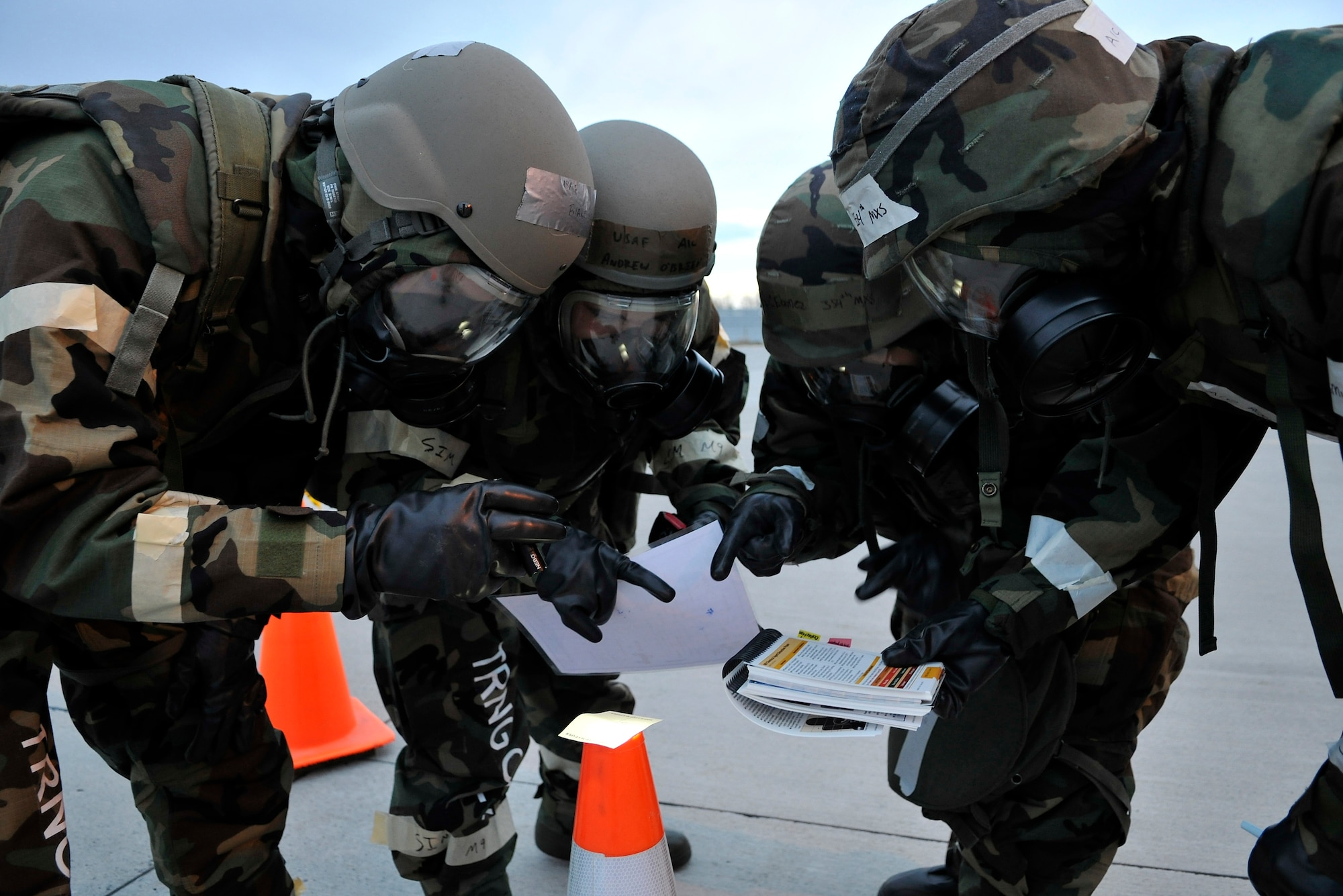 Airmen check M-8 paper for contamination during a training evaluation Oct. 23, 2009, Eielson Air Force Base, Alaska. The evaluation tests the ability of Airmen on how to survive and operate in a chemical, biological, radiological, nuclear and high yield explosive environment. The Airmen are assigned to the 354th Maintenance Squadron (U.S. Air Force photo/Staff Sgt. Christopher Boitz)