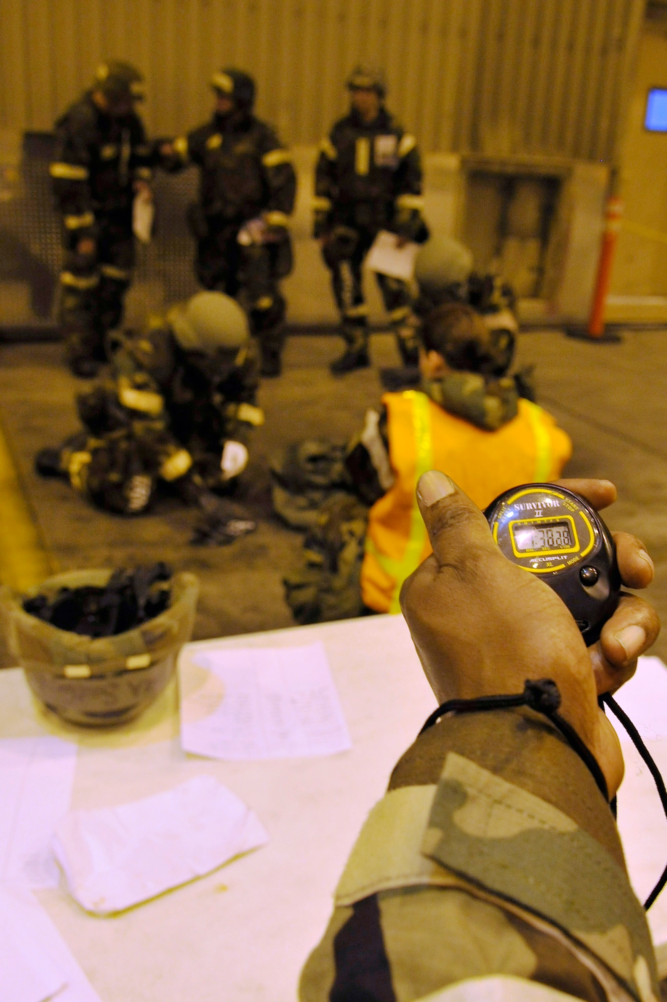 Airmen don gas masks and protective equipment during a timed training evaluation Oct. 23, 2009, Eielson Air Force Base, Alaska. The evaluation tests the ability of Airmen on how to survive and operate in a chemical, biological, radiological, nuclear and high yield explosive environment. (U.S. Air Force photo/Staff Sgt. Christopher Boitz)
