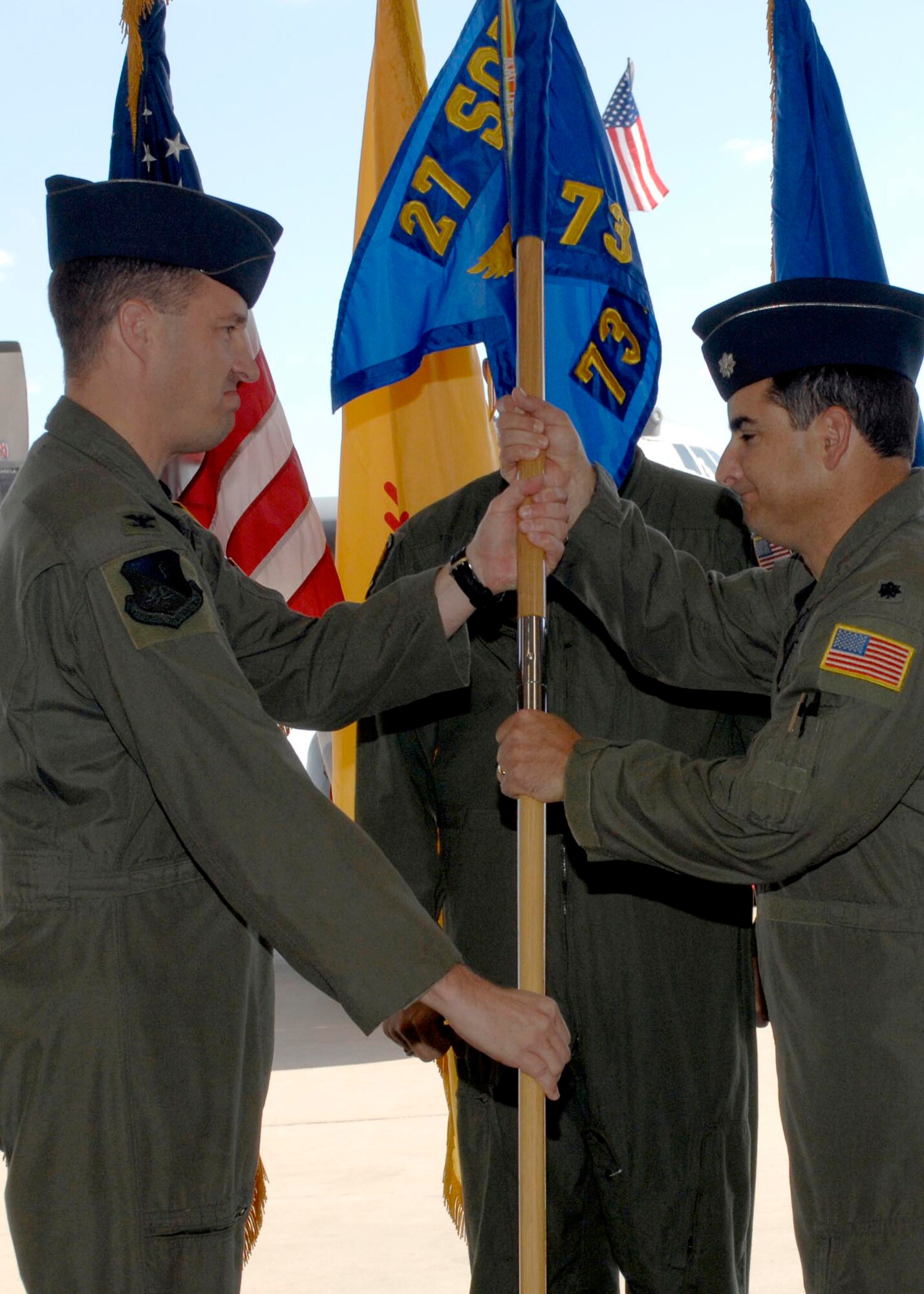 CANNON AIR FORCE BASE, N.M. -- Col James Cardoso, 27th Special Operations Group commander, hands the 73rd Special Operations Squadron guideon to Lt. Col. Kevin Cabanas, 73 SOS commander, on Oct. 23.  Col. William Wolfe relinquished command of the squadron after heading it since Feb. 15, 2008.  (U.S. Air Force photo by Airman 1st Class James Bell)