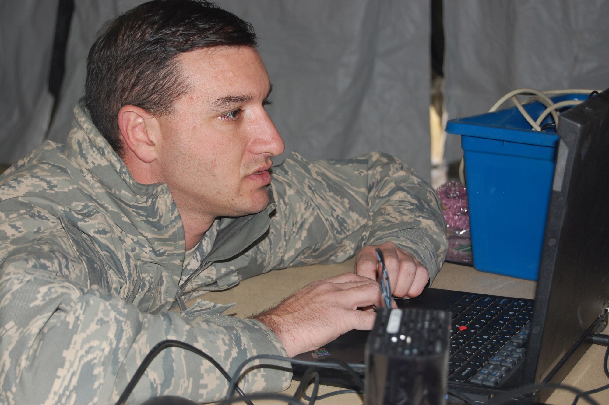 Tech. Sgt. Robert Luongo, 341st Communications Squadron network administrator, tests intranet connectivity after setting up computers in a tent Oct. 1, 2009, on the flight line during a Response Task force exercise. (U.S. Air Force photo./Airman 1st Class Kristina Overton)