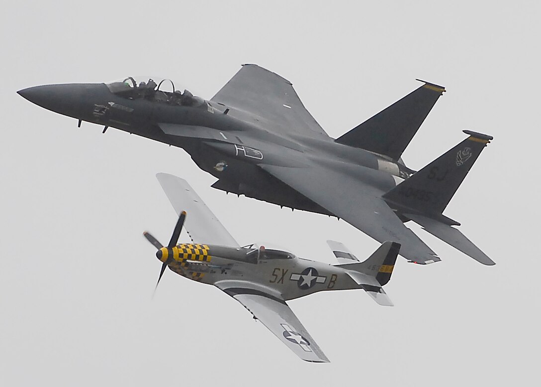 An F-15E Strike Eagle and P-51 Mustang make one of a series of passes Oct. 10 during a Heritage Flight at Sheppard's 2009 Open House and Air Show. The flights gives air show spectators an opportunity to see the Air Force's past and present in flight together. More than 23,000 spectators turned out for the two-day event. (U.S. Air Force photo/Harry Tonemah)