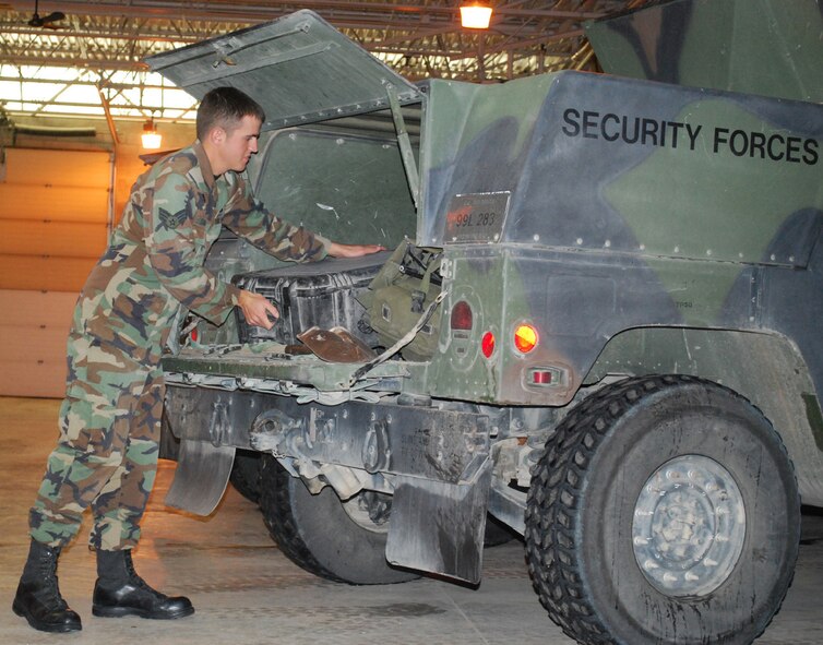 Senior Airman Nathan Stroven, 741st Missile Security Forces Squadron Convoy Response Force member, loads equipment into a HUMVEE Oct. 12, 2009, in the CRF bay. The CRF is responsible for escorting missile maintenanance teams to and from the missile complex, and provide security while resources are being attached to the missile. (U.S. Air Force photo/Airman 1st Class Kristina Overton)