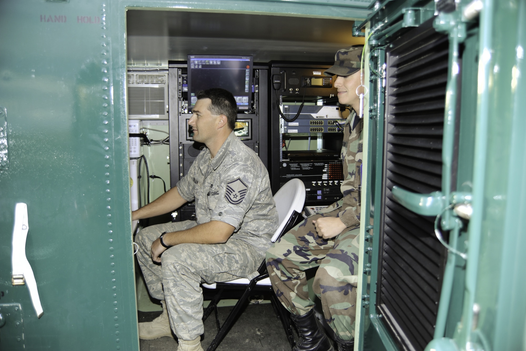 Master Sgt. Chris Wilson and Tech. Sgt. Ray Cozino, both from the Montana Air National Guard, keep information flowing from the 120th Fighter Wing's Communications Vehicle Oct. 15, 2009, during an RTF exercise here. (U.S. Air Force photo/Beau Wade)
