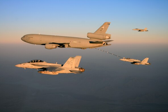 From left, an F/A-18F Super Hornet aircraft assigned to the "Black Aces" of Strike Fighter Squadron (VFA) 41 flies beside an Air Force KC-10 Extender aircraft as it refuels one of two F/A-18C Hornet aircraft assigned to VFA-97 during a flight over Afghanistan on Oct. 15, 2009. The F/A-18s are part of the USS Nimitz (CVN 68) Carrier Strike Group, which is on a routine deployment to the U.S. 5th Fleet area of operations. (U.S. Navy Photo/Lt. j.g. Kyle Terwilliger) 