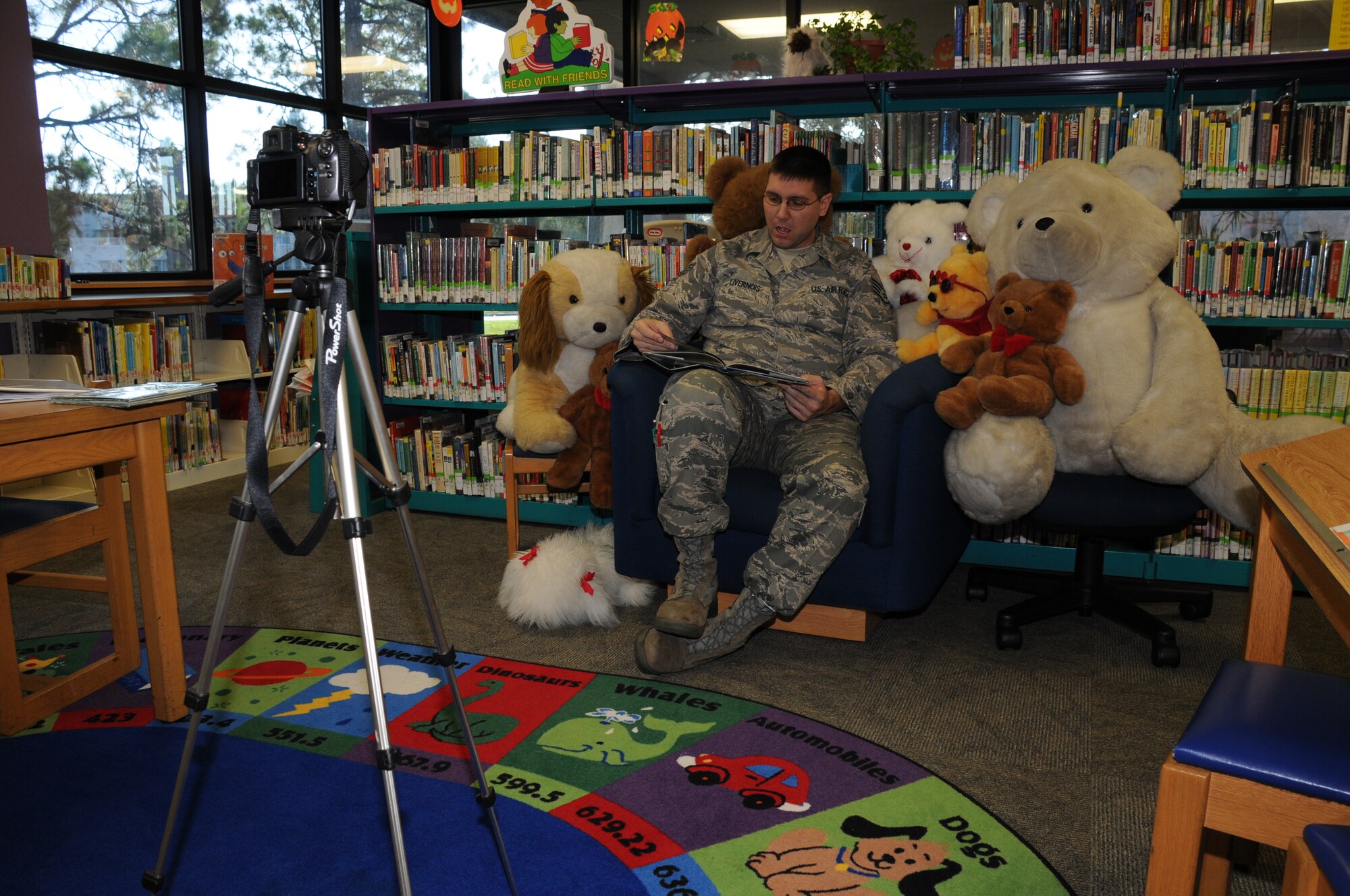 Staff Sergeant Richard Livernois reads to his children as part of "Operation Storytime" at the base library. 