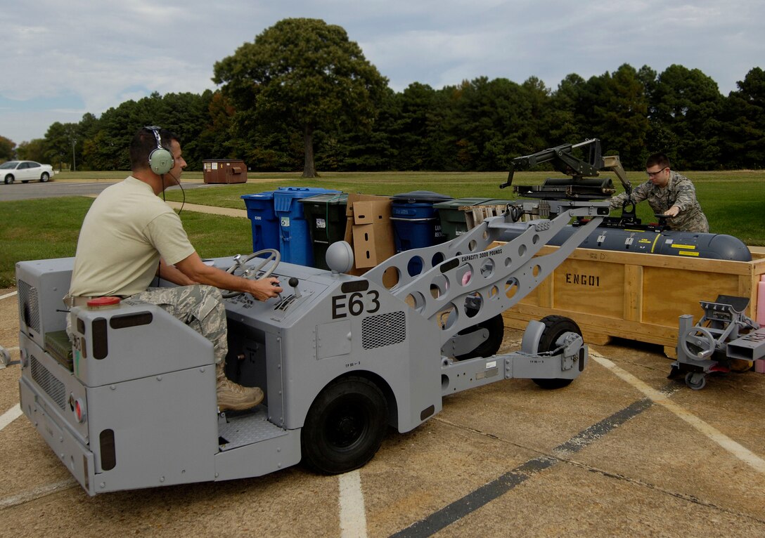 LANGLEY AIR FORCE BASE, Va. – Master Sgt. Darryl LaBrie and Staff Sgt. Eric Breault, 158th Fighter Wing Detachment 1, Vermont Air National Guard avionics specialists, lift a fourth generation Advanced Targeting LITENING Pod from a shipping crate here Oct 23. The first operational testing of the pods will occur during Bold Quest 2009, an Advanced Concept Technology Demonstration, which brings together nearly 1,000 professional warfighters and contractors from 11 countries and across the U.S. military in a field environment.  (U.S. Air Force photo/Airman Rebecca Montez)