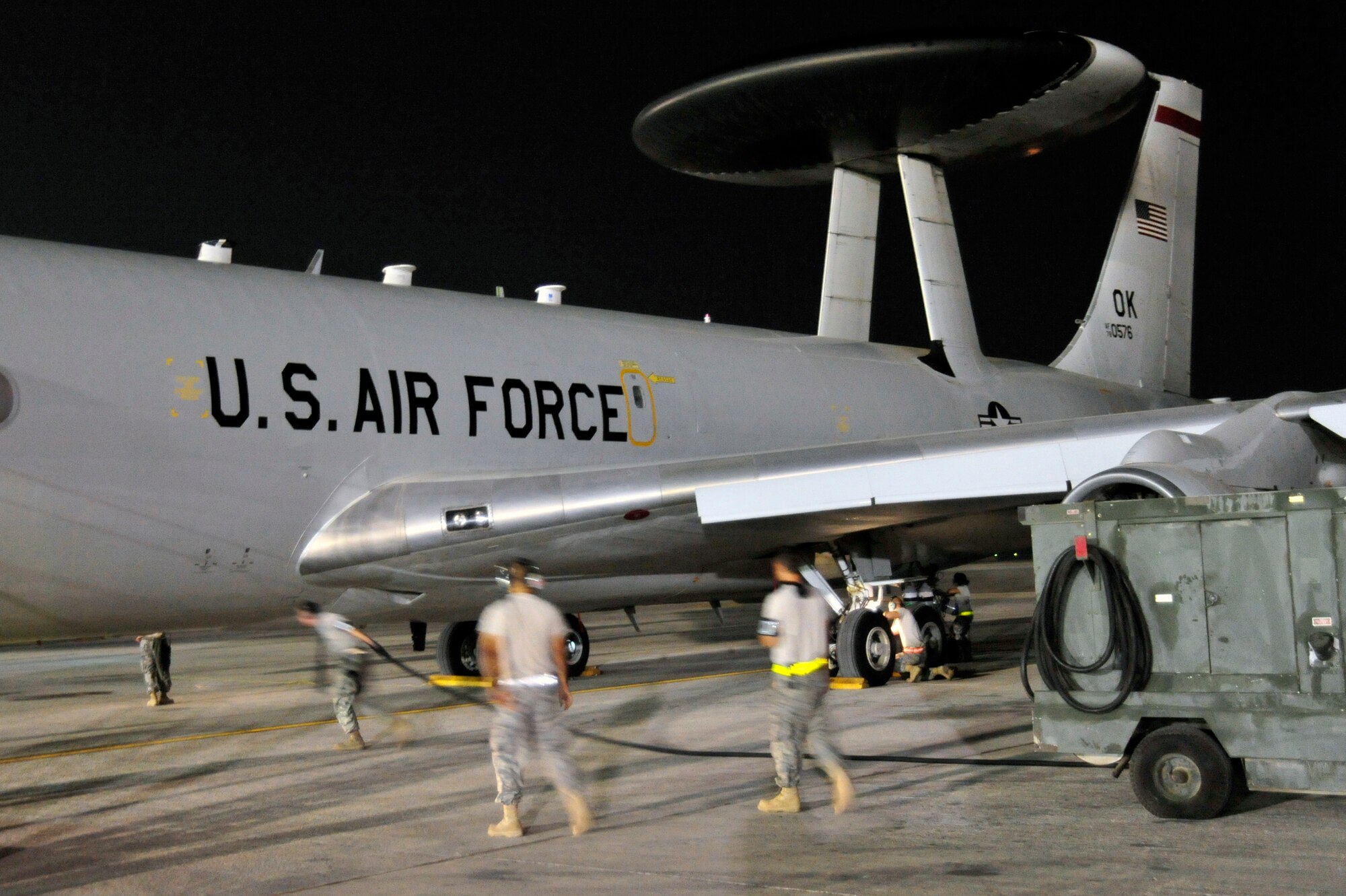 SOUTHWEST ASIA -Airmen of the 960th Expeditionary Airborne Air Control Squadron unravel the cable on a power unit to provide external power to an E-3 Sentry aircraft Oct. 21, 2009. The Airmen recovered the airborne warning and control system aircraft, following an Operation Enduring Freedom mission. (U.S. Air Force photo/Tech. Sgt. Charles Larkin Sr)