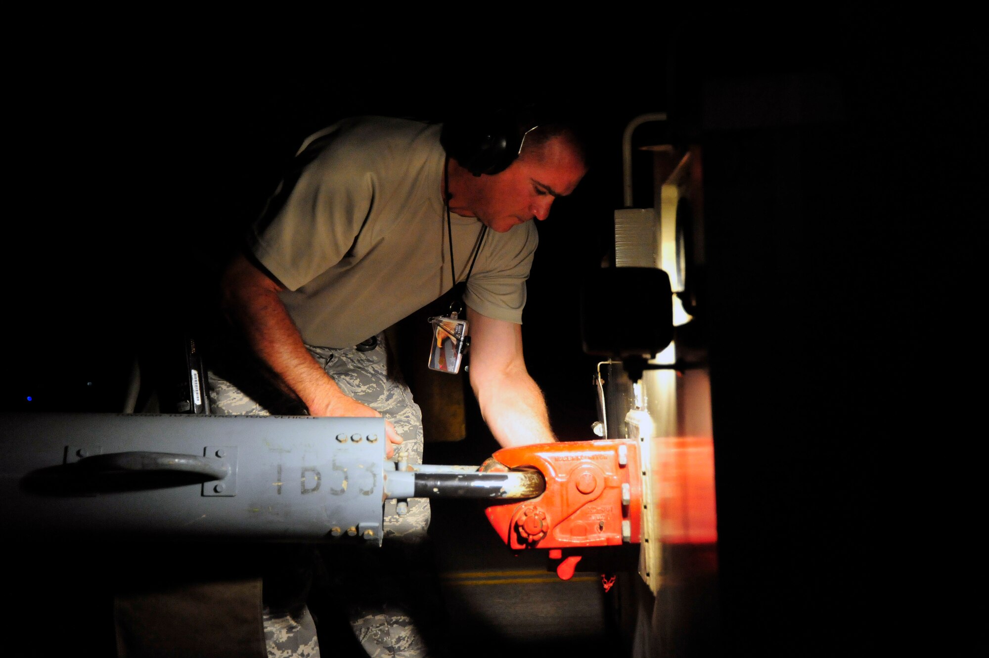 SOUTHWEST ASIA -Master Sgt. Allan George, 960th Expeditionary Airborne Air Control Squadron, closes the pintle hook on the tow vehicle to reposition an E-3 Sentry aircraft Oct. 21, 2009. Sergeant George is the production superintendant deployed from Tinker Air Force Base, Okla., and grew up in Northfield, Vt. (U.S. Air Force photo/Tech. Sgt. Charles Larkin Sr)