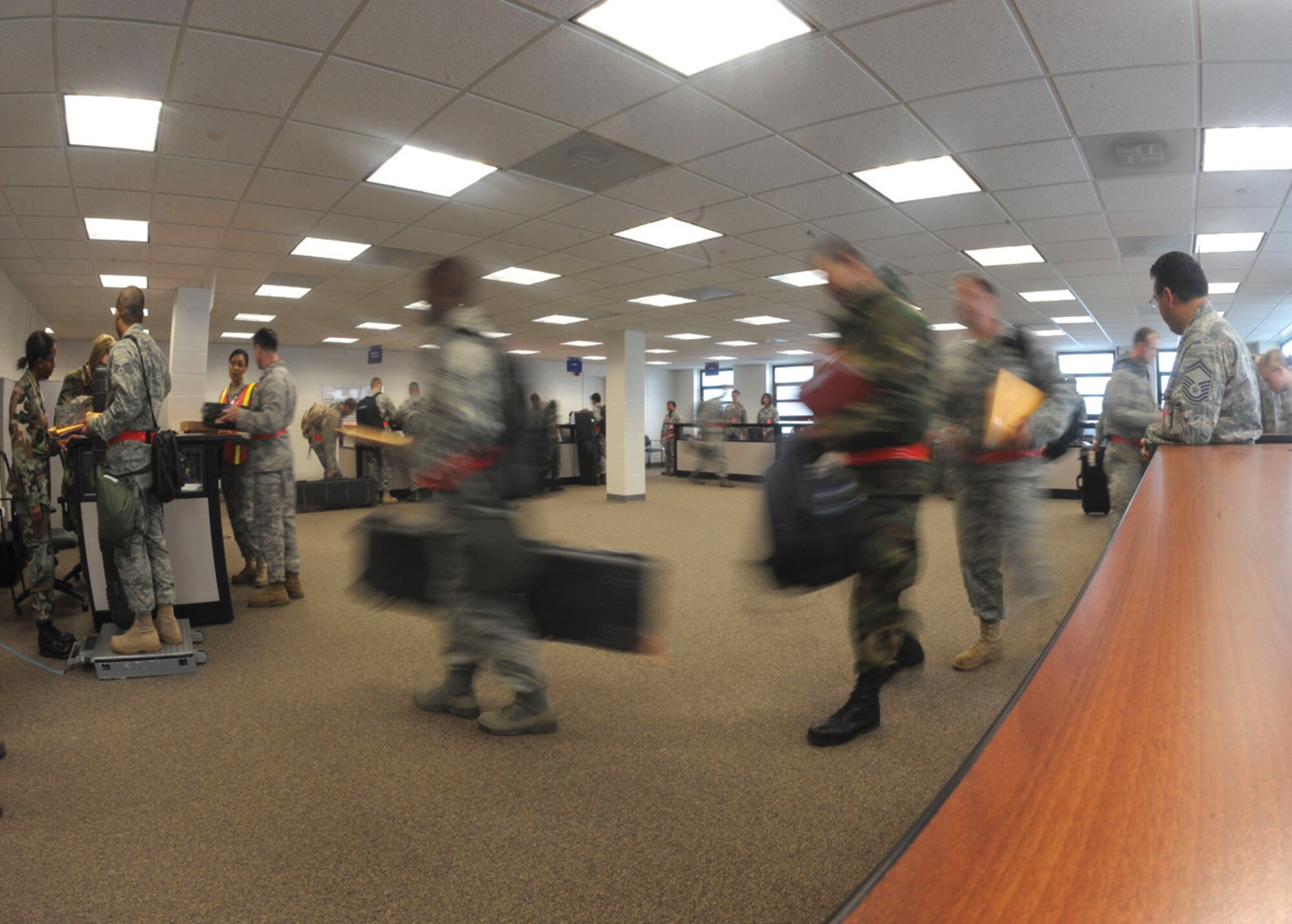 Airmen with the 89th Aerial Port Squadron process through the Joint Base Andrews Installation Deployment Readiness Center prior to departure Sunday to Alpena, Mich. The 316th Wing and the 79th Medical Wing took part in the 89th Airlift Wing Operational Readiness Inspection while also processing a real-world training mission. (U.S. Air Force photo/ Senior Airman Steven R. Doty)