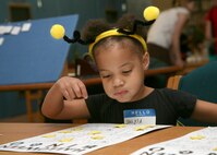 Jalysa Dillard, daughter of Samantha Dillard, plays Halloween Bingo at the Lackland Library Oct. 17. Approximately 180 people attended this year's bash which featured a costume contest, fortune teller, haunted house, scary crafts, and story by flashlight. (U.S. Air Force photo/Robbin Cresswell)