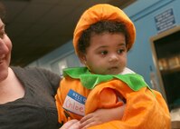 Chloe Hamilton, daughter of Randi Hamilton, shows off her pumpkin costume during the Lackland Library Magical Bash Oct. 17. The bash gave children an opportunity to wear their favorite costume and participate in a costume contest. (U.S. Air Force photo/Robbin Cresswell)