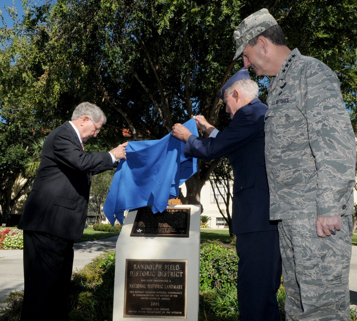 Gen. Stephen Lorenz, Air Education and Training Command commander, looks on as former Randolph Air Force Base cadets, Maj. Gen. (retired) William Acker, left, and Col. (retired) Donald Robison, unveil the plaque at the Cadet Circle dedication ceremony in the AETC circle drive. The circular courtyard between the AETC headquarters building and the command’s Lahm Conference Center was named Cadet Circle today to honor more than 16,000 aviation cadets and student pilots who received their pilot training here.  The Army Air Corps Aviation Cadet Program began during World War I and was conducted at Randolph from 1931 to 1965.  In 1943 the mission here changed when the Central Instructor's School moved to Randolph. In 1947 the cadets came back along with basic flying training and remained here until cadet training was phased out at Randolph in 1951. The new monument, centered in the middle of the courtyard, honors the men who were the primary reason for the existence of the base itself—cadets who lived, trained, and in some cases, died at Randolph. (U.S. Air Force/ Rich McFadden) 