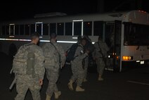 HICKAM AIR FORCE BASE, Hawaii -- Troops from the 25th Infantry Division
out of Schofield Barracks board a bus after a long flight home Oct. 23. More than 143 troops flew into Hickam's flightline and 735th Air Mobility Squadron passenger terminal here upon return from Iraq, where they were deployed for more than 12 months in support of Operation Iraqi Freedom. The 735th AMS is an Air Mobility Command tenant unit here, supporting airlift movement of people and passengers around the world. In the last year, the 735th AMS has assisted in transporting 11,077 personnel on 72 missions for the Army's 25th ID; 2,518 personnel on 16 missions from
the Kaneohe Marine Corps Base, Hawaii; and 5,720 other personnel on 50 missions in support of Operations Iraqi and Enduring Freedom. (U.S. Air Force photo/Senior Airman Gustavo Gonzalez)
