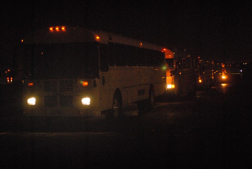 HICKAM AIR FORCE BASE, Hawaii -- Five buses wait for 25th Infantry Division troops stationed out of Schofield Barracks to unboard a plane after a long flight home Oct. 23. More than 143 troops flew into Hickam's flightline and 735th Air Mobility Squadron passenger terminal here upon return from Iraq, where they were deployed for more than 12 months in support of Operation Iraqi Freedom. The 735th AMS is an Air Mobility Command tenant unit here, supporting airlift movement of people and passengers around the world. In the last year, the 735th AMS has assisted in transporting 11,077 personnel on 72 missions for the Army's 25th ID; 2,518 personnel on 16 missions from the Kaneohe Marine Corps Base, Hawaii; and 5,720 other personnel on 50 missions in support of Operations Iraqi and Enduring Freedom. (U.S. Air Force photo/Senior Airman Gustavo Gonzalez)

