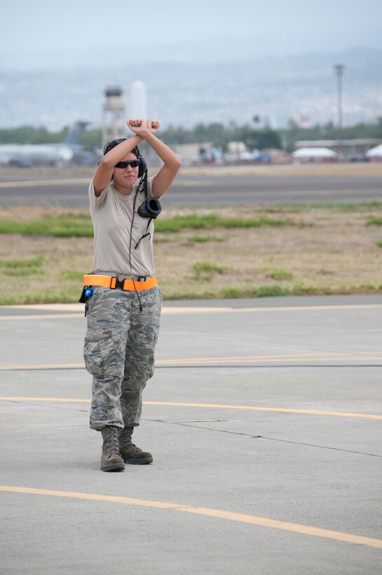 U.S. Air Force Senior Airman Colleen Corrigan, from the 144th Fighter Wing, California Air National Guard, marshals an  F-16 Fighting Falcon aircraft on Hickam Air Force Base, Hawaii, before an air-to-air mission during exercise Sentry Aloha Sept. 18, 2009. The exercise brings dissimilar combat assets to Hickam AFB to train with the Hawaii Air National Guard's 199th Fighter Squadron. (U.S. Air Force photo by Staff Sgt. Charles P. Vaughn) (Released)
