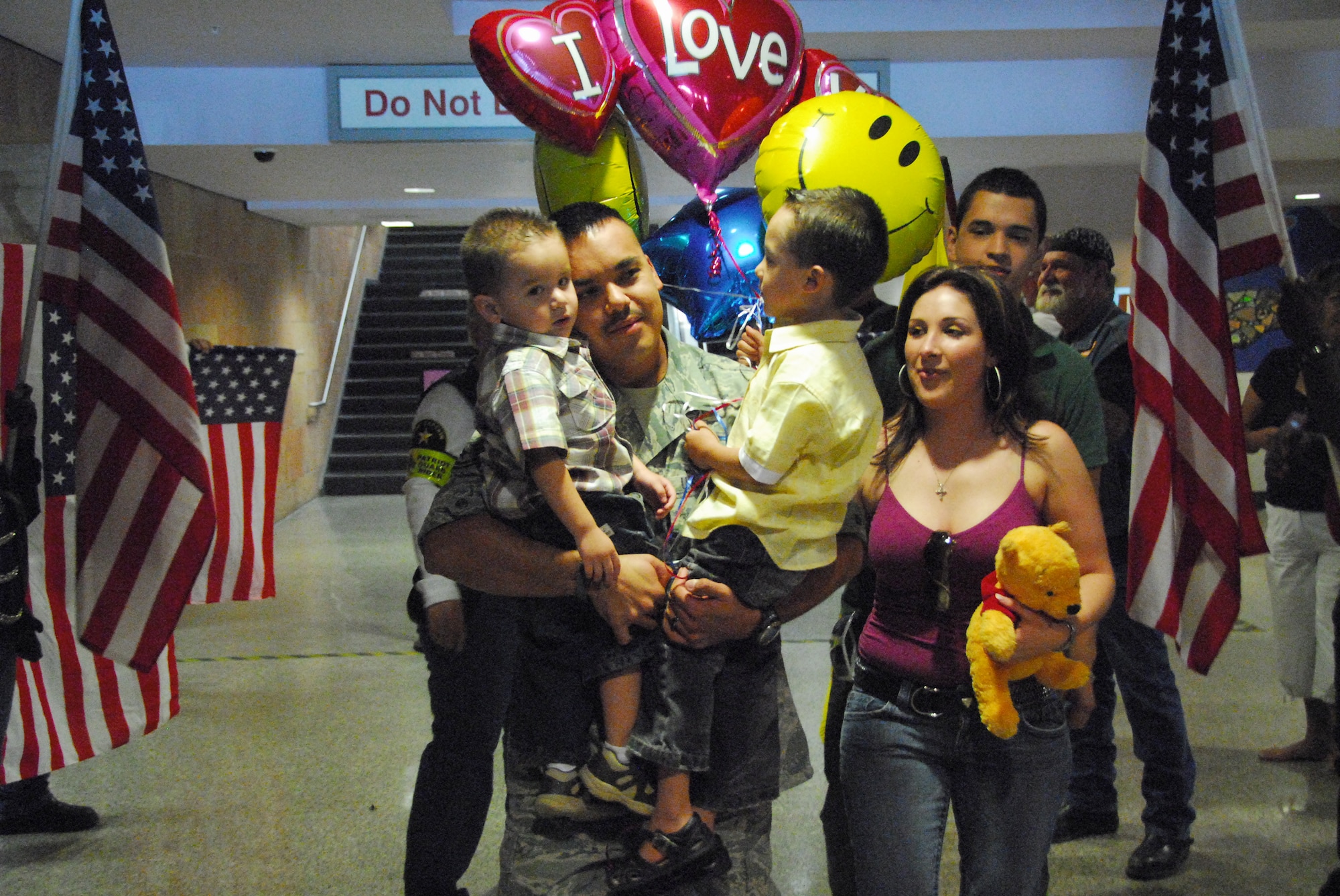 Tech. Sgt. Santos Flores,162nd Force Support Squadron, is greeted by family in the Tucson Airport baggage claim after a four-month deployment to Southwest Asia, Oct. 22.  (Air National Guard photo by Master Sgt. David Neve)