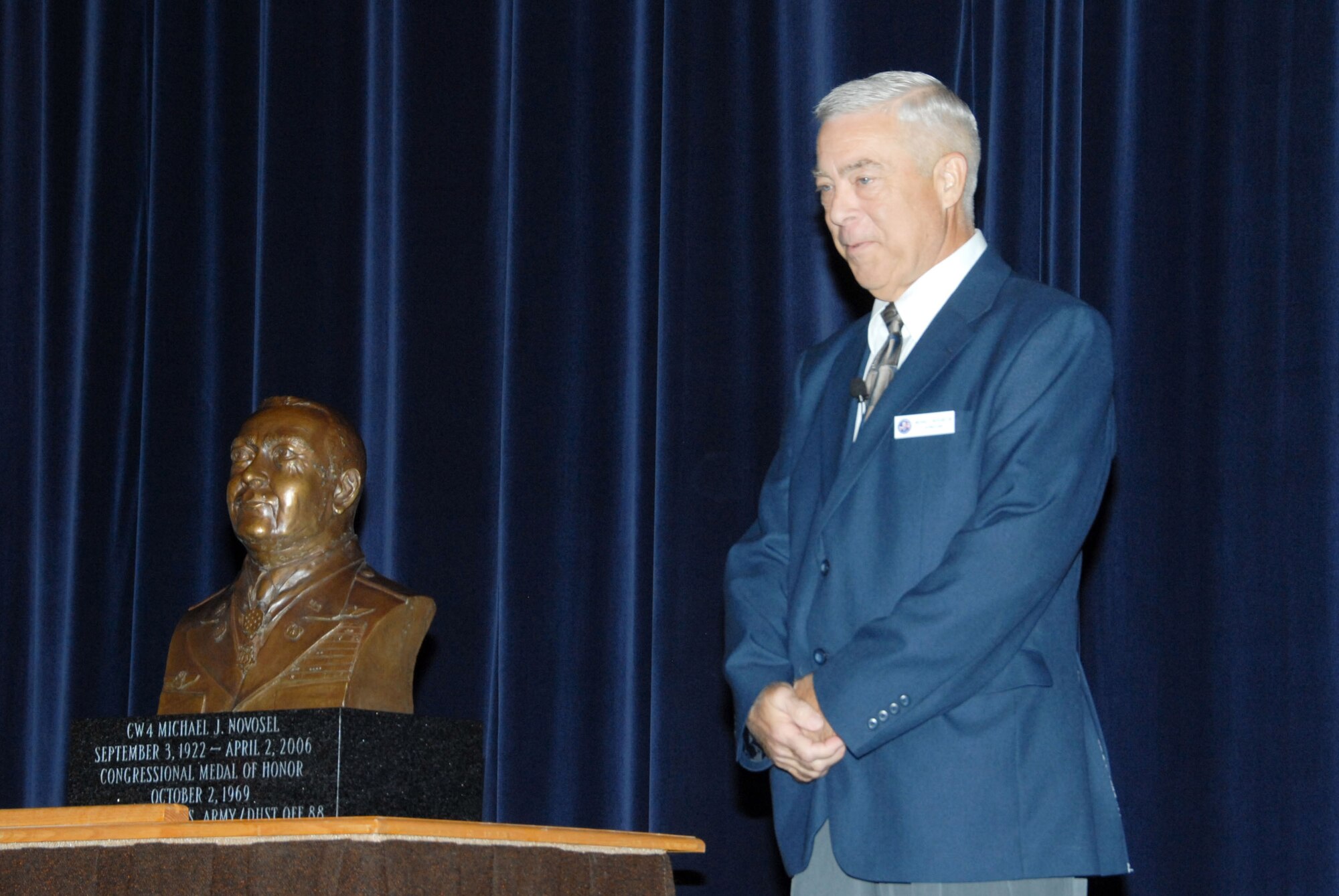 During a ceremony at Air Command and Staff College Wednesday to dedicate a bronze bust of his father, retired Army Chief Warrant Officer 4 Michael Novosel Jr. talked about his dad, CW4 Michael Novosel Sr. The Medal of Honor was bestowed upon CW4 Novosel Sr. in Oct. 1969 for saving the lives of 29 soldiers during an engagement of the Vietnam War. (U.S. Air Force photo/Bennett Rock) 
