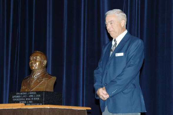 During a ceremony at Air Command and Staff College Wednesday to dedicate a bronze bust of his father, retired Army Chief Warrant Officer 4 Michael Novosel Jr. talked about his dad, CW4 Michael Novosel Sr. The Medal of Honor was bestowed upon CW4 Novosel Sr. in Oct. 1969 for saving the lives of 29 soldiers during an engagement of the Vietnam War. (U.S. Air Force photo/Bennett Rock) 
