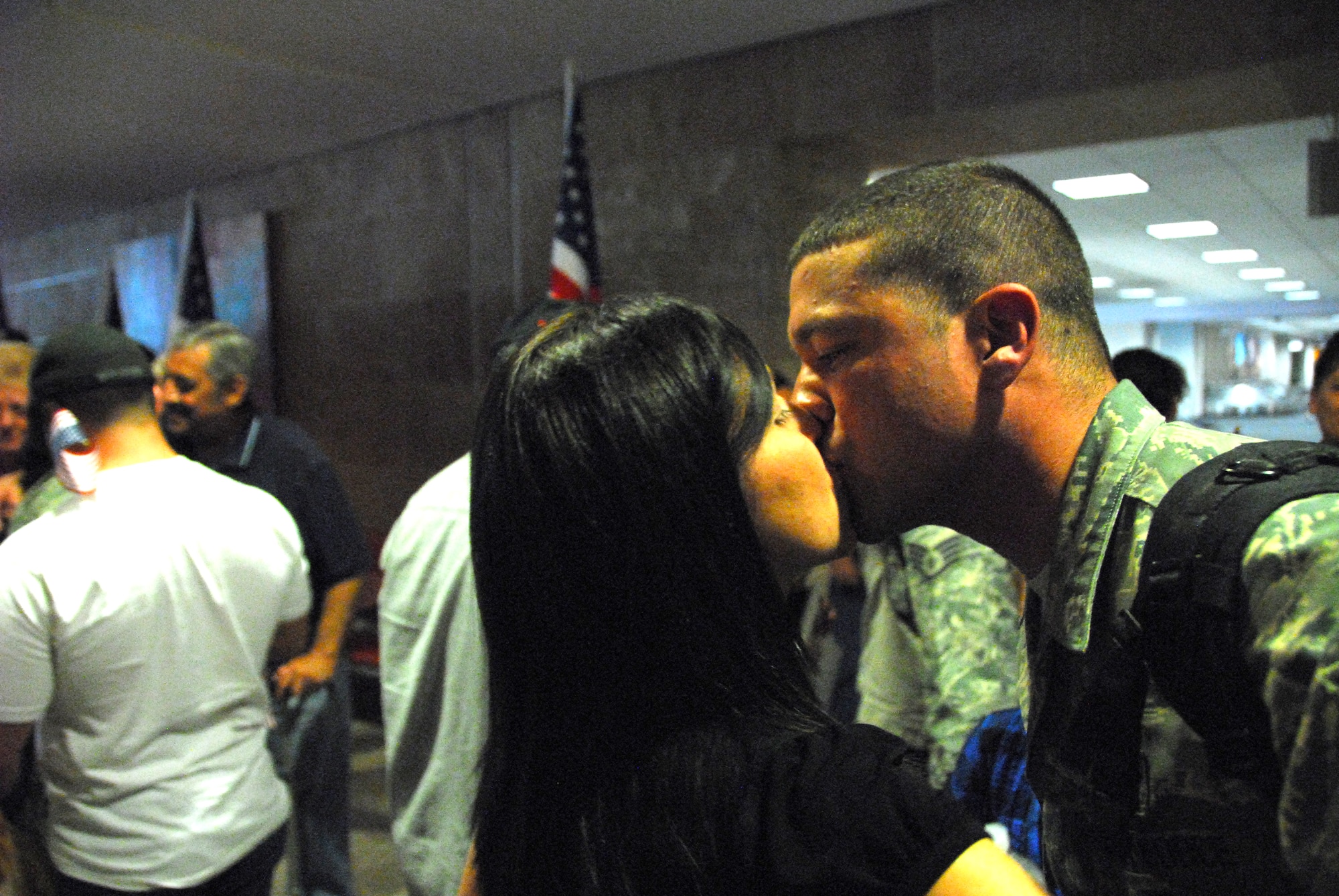 Staff Sgt. Eric Klajda, 162nd Force Support Squadron, is greeted by family in the Tucson Airport baggage claim after a four-month deployment to Southwest Asia, Oct. 22.  (Air National Guard photo by Master Sgt. David Neve)