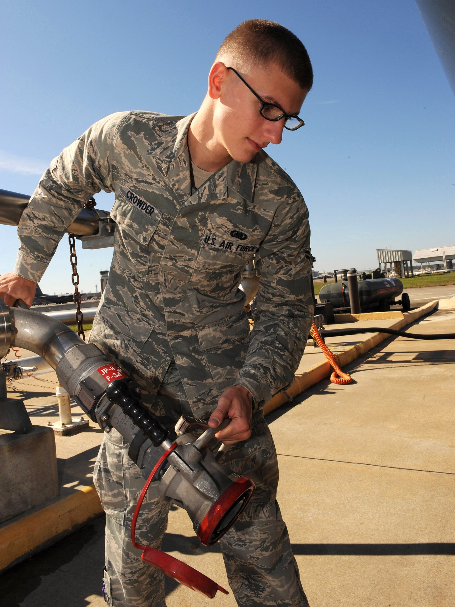 Airman 1st Class Kevin Crowder positions a pantograph arm to attach to an R-11 refueling truck to begin refueling 6,000 gallons of jet fuel to service the C-130 Hercules fleet Oct. 21, 2009, at Little Rock Air Force Base, Ark. Airman Crowder is a 19th Logistics Readiness Squadron fuels distribution operator. (U.S. Air Force photo/Staff Sgt. Chad Chisholm) 