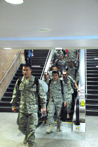 Guardsmen assigned to the 162nd Force Support Squadron ride an escalator to the baggage claim area where they are greeted by family and friends after a four-month deployment to Southwest Asia, Oct. 22. (Air National Guard photo by Master Sgt. David Neve)
