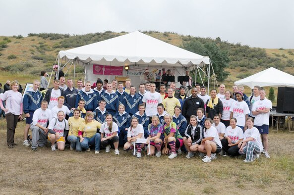 Participants in the Colorado Springs' Susan G. Komen Race for the Cure pose for a photo during the days activities. Cadets pitched in on race day from 4 a.m. to 2 p.m. to direct traffic in darkness, work the information tent, unload refreshment products, assist in stage recognition of the survivors and direct more than 7,000 participants through the race course by manning water stations, the finish line and on buses.