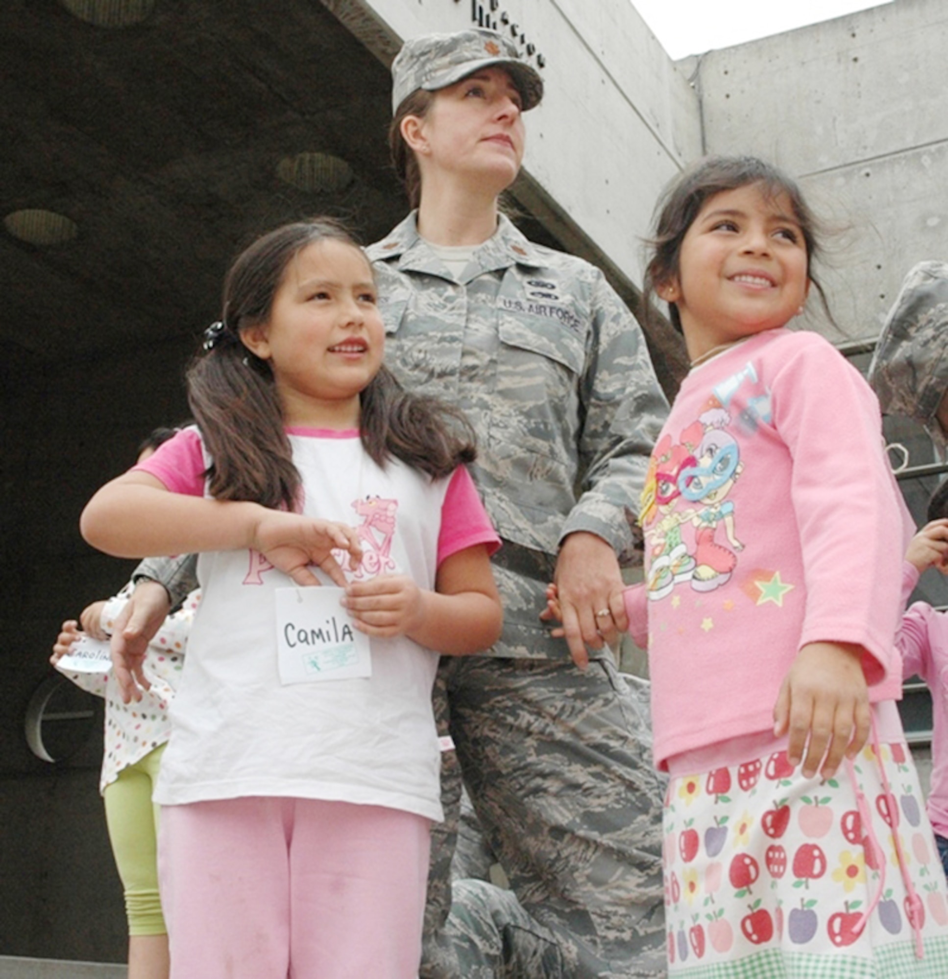 Maj. Jana Nyerges waits with children from the Angels Community Center outside a museum prior to sponsoring the children's admission to the science exhibits Oct. 13, 2009, in Santiago, Chile. Airmen decided to use their first day in Chile to sponsor a group of at-risk children during a visit to the museum. Major Nyerges is a member of Air Forces Southern participating in a subject matter exchange with the Chilean air force. (Courtesy photo) 