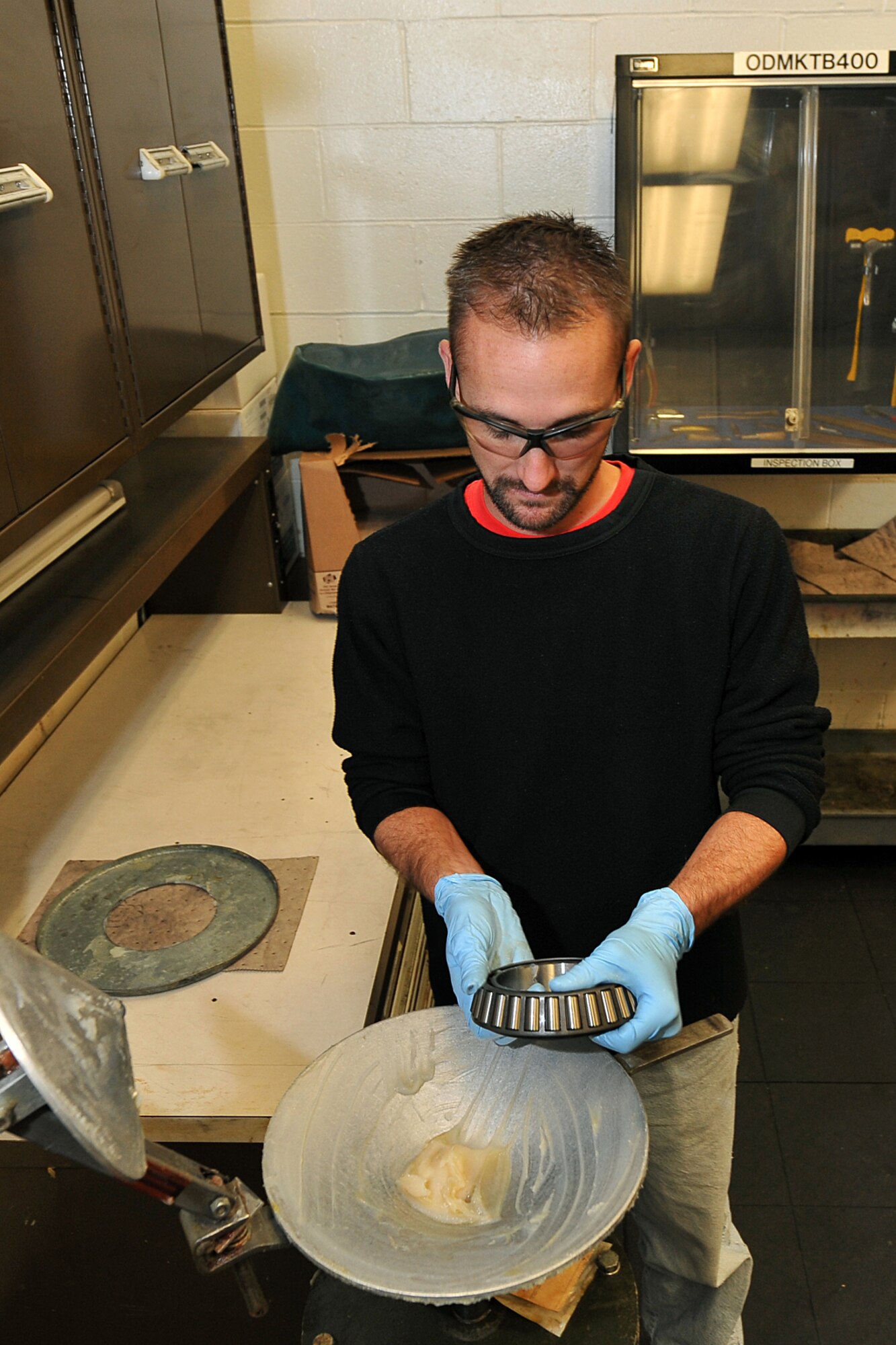 OFFUTT AIR FORCE BASE, Neb. - Isaac Balaun, an aircraft mechanic in the 55th Maintenance Squadron's isochronal phase inspection dock, packs wheel bearings with grease Oct. 15 to keep them from overheating once a wheel is installed on an aircraft. In addition to working in the ISO dock in the Bennie Davis Maintenance Facility, the approximately 40 aircraft maintainers also work in the wheel and tire back shop when necessary.  Each year maintainers process about 400 wheels and tires for C-135 variant and E-4B aircraft here.

U. S. Air Force photo by Charles Haymond
