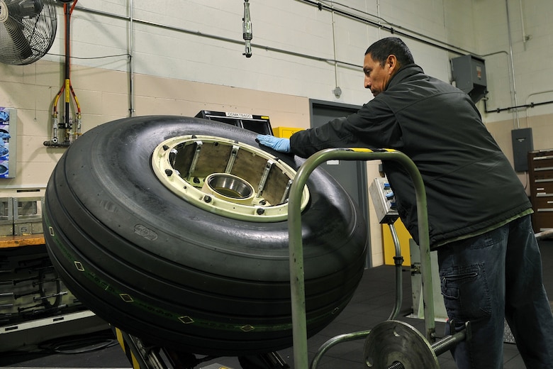 OFFUTT AIR FORCE BASE, Neb. -  Greg Sanchez, an aircraft mechanic in the 55th Maintenance Squadron isochronal phase inspection dock, places a tire on a universal wheel build up machine to separate the rim from the tire in the wheel and tire shop Oct. 15. In addition to working in the ISO dock in the Bennie Davis Maintenance Facility, the approximately 40 aircraft mechanics assigned also man the wheel and tire back shop when necessary. Each year they process about 400 wheels and tires for the C-135 variants and E-4B aircraft here. 

U.S. Air Force photo by Charles Haymond