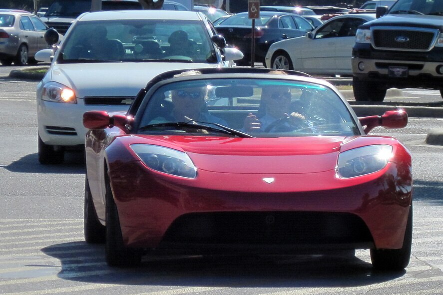 Col. Bruce McClintock, 96th Air Base Wing commander drives a 2009 Tesla Roadster into the Main Exchange parking lot with David Erickson, Gulf Power, in the passenger seat. The all-electric car was on display at Eglin’s Energy Expo, Oct. 21. The Roadster is capable of going from 0-60 mph in 3.7 seconds, and a full charge costs approximately $5 in electricity and allows the car to go about 200 miles. (U.S. Air Force photo/Mike Spaits)