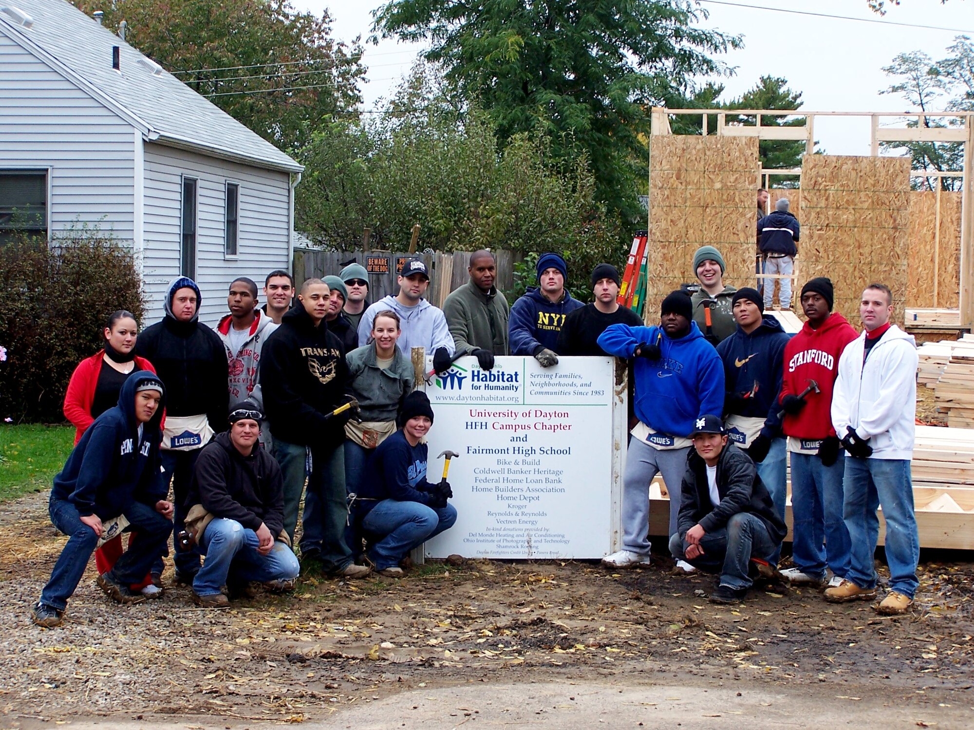 Twenty-one members form the 88th Security Forces Squadron gather for a photo in front of the Habit for Humanity house they volunteered to help erect. 