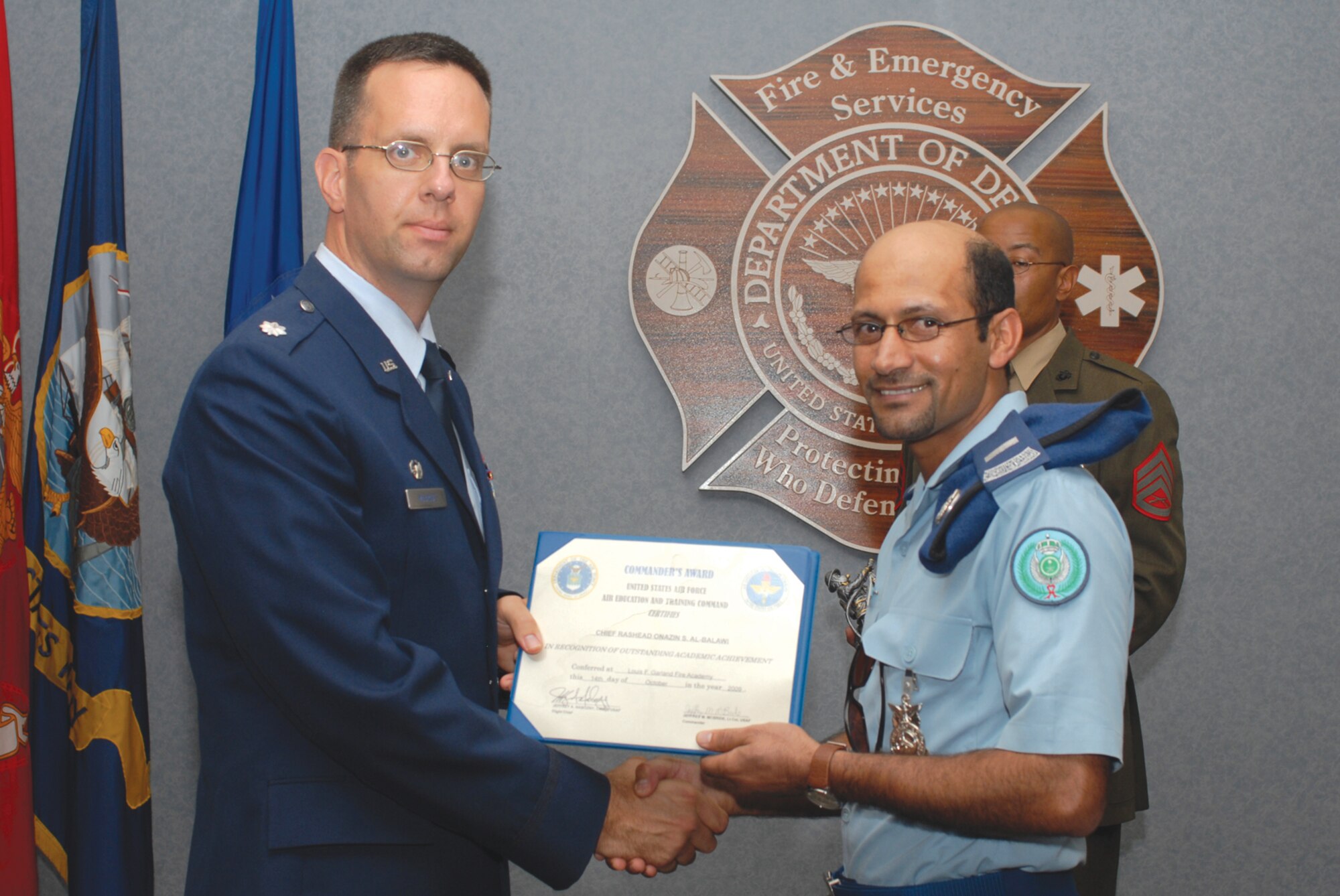 Lt. Col. Jeffrey McBride, 312th Training Squadron commander presents Chief Master Sgt. Rasheed Al Balawi, Royal Saudi Air Force, with the Commander’s Award for Outstanding Academic Achievement on Oct. 14. Chief Rasheed is recognized as one of the first Saudi Arabian fire fighters to complete the demanding 66-day Fire Fighter Apprentice course here at the Loius F. Garland Department of Defense Fire Academy. (U.S. Air Force photo by Staff Sgt. Laura McFarlane) 
